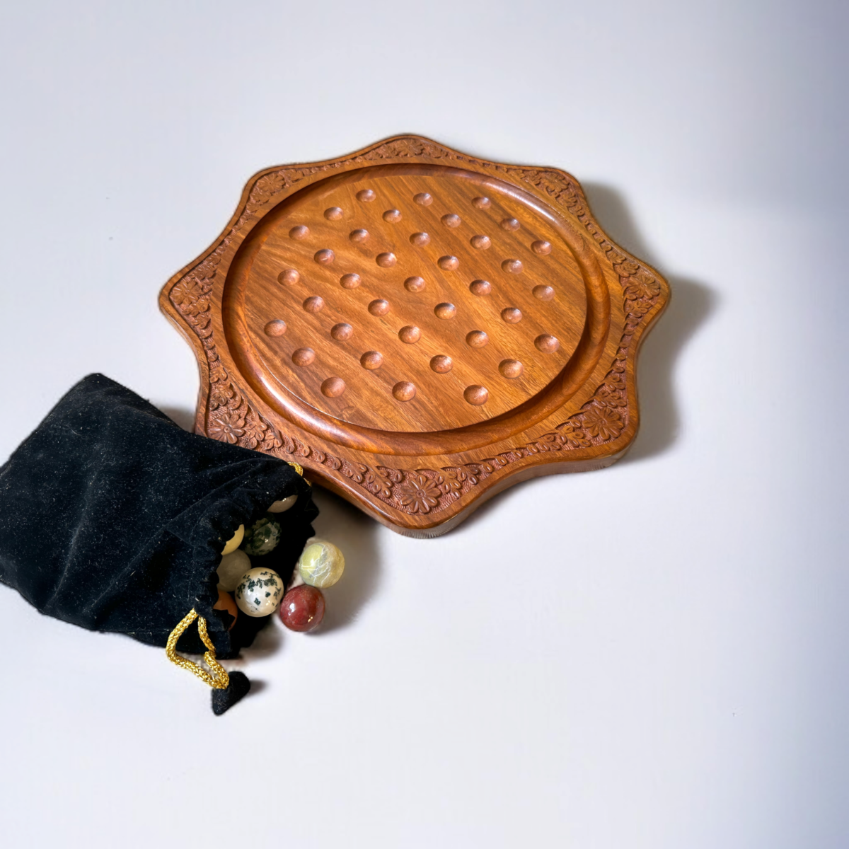 Round wooden marble solitaire board, showcasing craftsmanship with natural marbles and a velvet bag as a thoughtful gift idea.