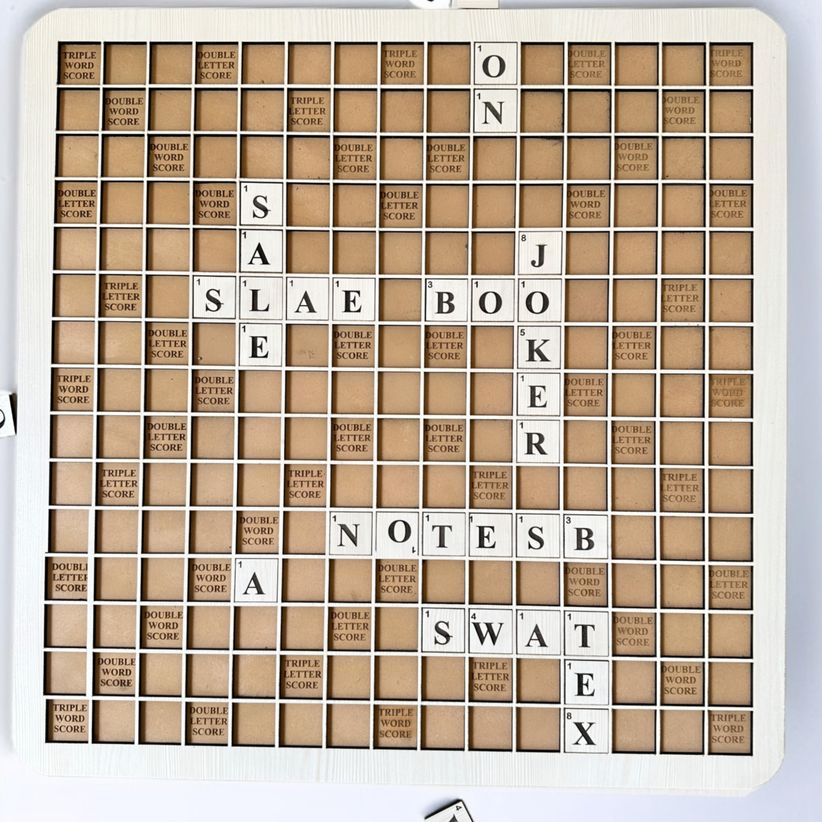 Close-up of 128 wooden Scrabble tiles included in the MDF board game set, showcasing durable craftsmanship and smooth lettering