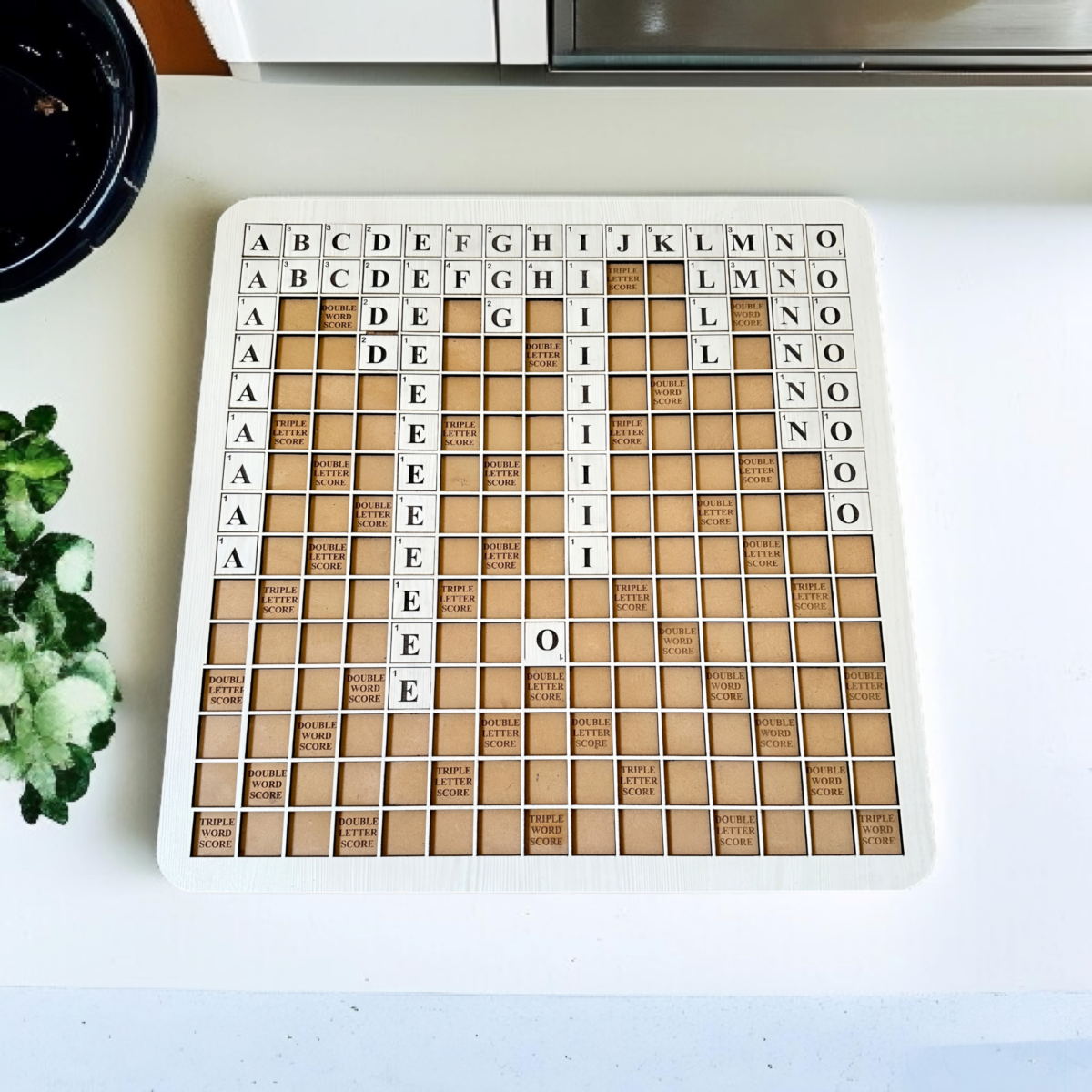 Gift-ready wooden Scrabble word game box with 18-inch board and 128 tiles, tied with a jute ribbon for eco-friendly packaging.